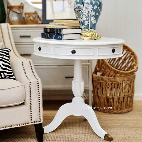 This Canalside Interiors Cobble Hill Large Round Table in distressed white is an ideal entry table for a grand foyer, evoking timeless Hamptons style.