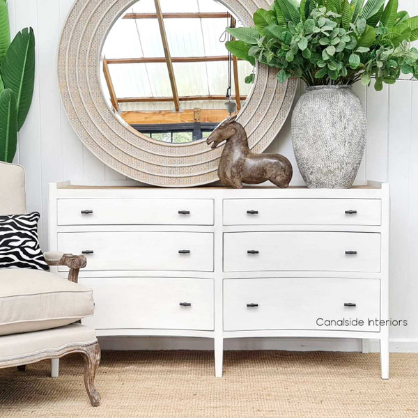 Frontal view of the Tweed Hill Rattan Grande Double Chest in distressed off-white, offering a serene addition to a light-filled bedroom.