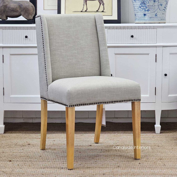 Leclerc Dining Chair, Sleek Sophistication in Cream Upholstery, Natural Oak Legs, Brass Stud Detail, Front Angled View