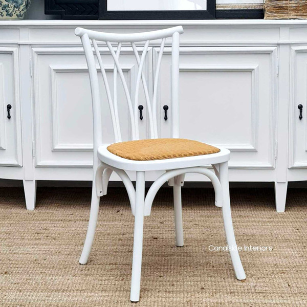 Front view of the Botanica Dining Chair in Distressed White with a natural rattan seat, showcasing its coastal-inspired elegance - Canalside Interiors