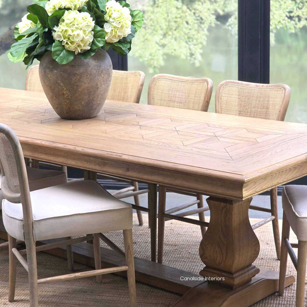 Front angled view of the Chesterton Oak Parquetry Dining Table 280cm showcasing its sculptural pedestal base and beautiful parquetry design.