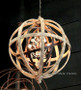 Adorn your living room with Canalside Interiors’ Kings Landing Chandelier, where the rustic charm of bronze and wood meets the sophistication of faceted crystal glass."