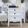 Full front-facing photo of the white Peninsula bedside styled with soft décor and neutral tones.