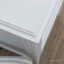 Close-up of the moulding detail along the drawer frame of the Peninsula white bedside.