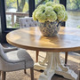 White Artisan Parquetry Round Dining Table featuring a handcrafted recycled timber top and decorative carved base