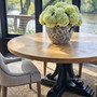 Black Artisan Parquetry Round Dining Table with recycled timber parquetry top and carved pedestal legs