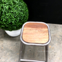 Close-up of the stool's wooden seat, showcasing the natural grain and texture contrasted with the industrial metal.