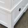 Detailed view of the wardrobe's handle design, marrying functionality with aesthetic beauty for a minimalist yet traditional look.