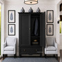 Front perspective of the Peninsula black wardrobe cupboard in situ in a Hamptons style bedroom,  demonstrating its spacious storage capabilities and practical organisation options.