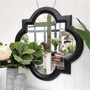 Detail of the distressed black finish, adding depth and texture to the mirror, enhancing its visual appeal.
