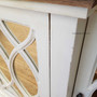 Detail shot focusing on the heavy distressing of the stone finish on the Marielle Sideboard, offering insight into its textural appeal.