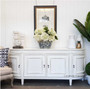In a library setting, the Francia Sideboard in distressed off white anchors the room with its traditional silhouette, complementing both colonial plantation and provincial styles