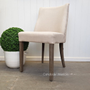 A single Bingley chair under soft lighting, creating a warm and inviting ambiance in a dining or living space.