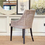 View from behind, focusing on the chair's curved rattan back, which adds both support and an element of design flair.