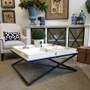 The table adorned with chic decorative items, demonstrating its capacity as both a statement piece and a functional serving table.