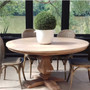 Front view of the Artisan Round Dining Table at Canalside Interiors, displaying its recycled timber craftsmanship and hand-carved pedestal base.