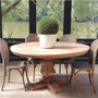 Front view of the Artisan Round Dining Table at Canalside Interiors, displaying its recycled timber craftsmanship and hand-carved pedestal base.