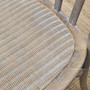 Close-up on the rattan seat of the Botanica Chair, highlighting the comfort and elegance of the slight padding and woven texture.