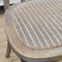 Close-up on the rattan seat of the Botanica Chair, highlighting the comfort and elegance of the slight padding and woven texture.