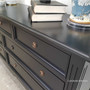 Close-up of the sideboard's minor distressing, highlighting the detailed craftsmanship and timeless style.