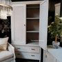 Interior view of the wardrobe, displaying the hanging rod and versatile removable shelves for organized storage.
