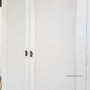 Detail shot of the distressed stone finish, emphasizing the wardrobe's unique texture and elegant appearance.