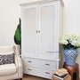 Angled perspective capturing the wardrobe's elegant stature and the intricate details of its rattan design.