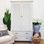 Frontal view of the Brielle Rattan Wardrobe Cupboard at Canalside Interiors, showcasing its distressed stone finish and stone rattan detailing.
