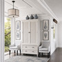 Angled perspective of the Brielle Rattan Wardrobe Cupboard in situ capturing the wardrobe's elegant stature and the intricate details of its rattan design.