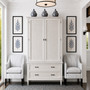 Frontal view of the Brielle Rattan Wardrobe Cupboard in situ at Canalside Interiors, showcasing its distressed stone finish and stone rattan detailing.