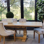 Front view of the Balmoral Parquetry Extension Dining Table set in a sunlit dining room, showcasing the natural parquetry top and the contrasting distressed grey base.