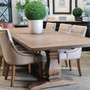 Side perspective of the table closed, focusing on the trestle pedestal base and its sophisticated hand-carved details.
