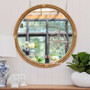 "Raffles Cane Mirror hanging in a bright living room, showcasing its natural finish and classic Plantation design - Canalside Interiors