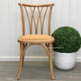 Front view of the Botanica Dining Chair in Natural with a natural rattan seat, showcasing its coastal-inspired elegance.