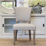 Front view of the Mimi Dining Chair in cream with weathered oak legs, displaying its sophisticated sensibility and classic Hamptons style.
