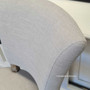 View of the Mimi Dining Chair, focusing on the chair's elegant silhouette and the fine detailing of its upholstery.