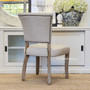 Zoomed-in view of the weathered oak legs of the Mimi Dining Chair, showcasing the natural beauty and texture of the wood.