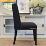 The winged back of the Leclerc Dining Chair not only provides comfort but also a regal presence, fitting for a coastal-themed home