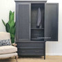 Captured in a well-lit room, the wardrobe's distressed charcoal/black finish complements any home style with its reflective quality and timeless design.
