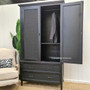 Interior shot revealing the wardrobe's practical hanging rod and adjustable, removable shelves for versatile storage options.