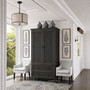Angled perspective of the Brielle Rattan Wardrobe Cupboard in black in situ in a classic hamptons home