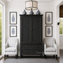 Front perspective of the Brielle Rattan Wardrobe Cupboard in black in situ in a modern hamptons home, showcasing its sophisticated rattan detailing and sleek design.