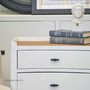 Detail shot of the distressed white finish, showcasing the attention to detail and the chic, timeless appeal of the bedside.