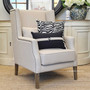 The armchair set in a Hamptons-style living room, illustrating its perfect fit within luxurious coastal-themed decors.