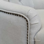 Profile shot showcasing the armchair's rolled arms and tufted back, blending traditional craftsmanship with modern elegance.