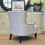 Rear perspective of the armchair, highlighting its sturdy construction and beautiful button tufted detailing.