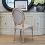 Sansa Chair's cream upholstery complements the rustic charm of a coastal living room - Canalside Interiors