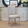 The Knightley Dining Chair, in limewash and cream linen, provides a chic and comfortable seating option, perfect for modern or classic dining spaces – Canalside Interiors.