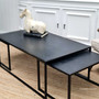 The smallest table being used as a standalone piece, placed beside a lounge chair as a chic side table.
