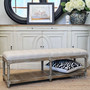 Lifestyle image of the ottoman in a cozy reading nook, providing both a chic seating option and additional storage space.